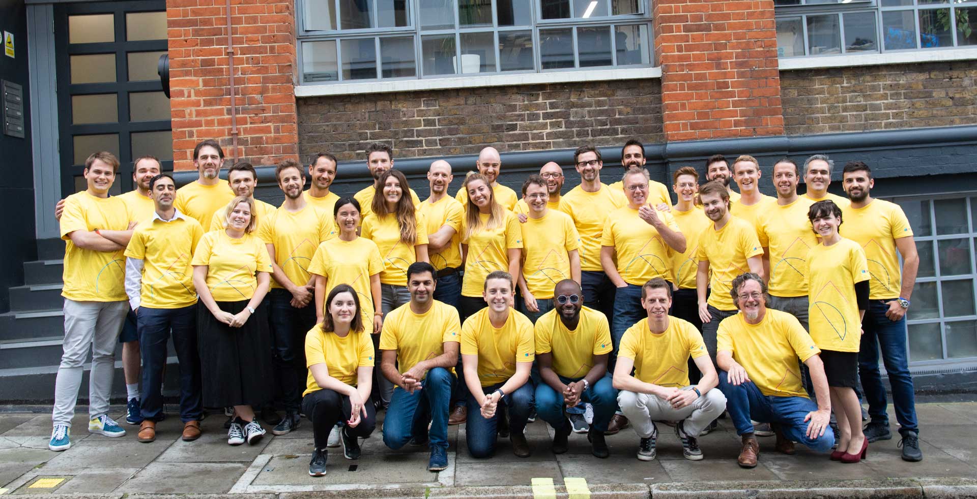 AppyWay Team outside the office in yellow shirts